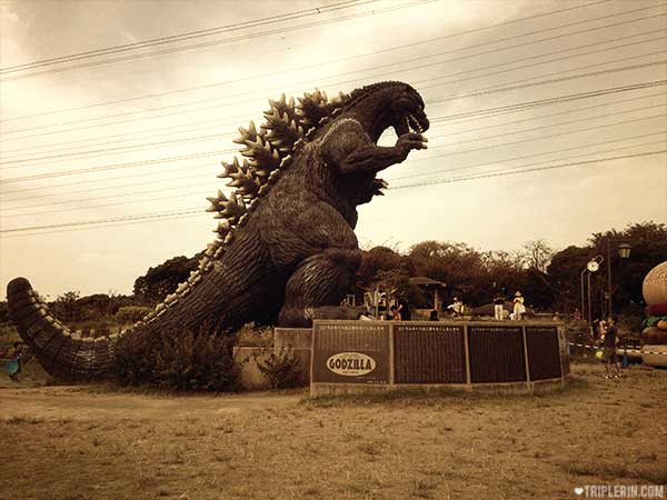 Man vs Godzilla. Except... you can hardly see the man...